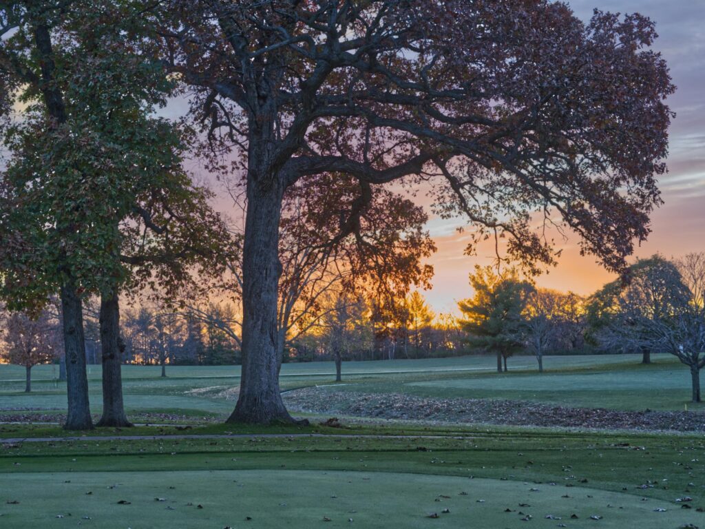golf hole at indian creek country club at sunset